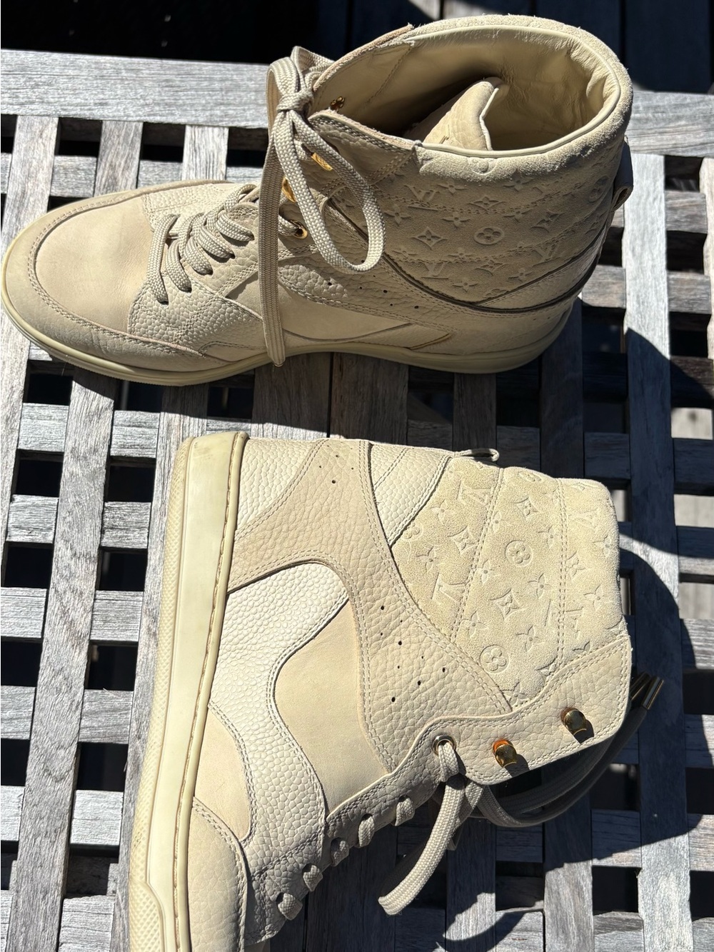 Louis Vuitton Cream Leather Lace-Up Wedge Sneakers with Gold Accents.
